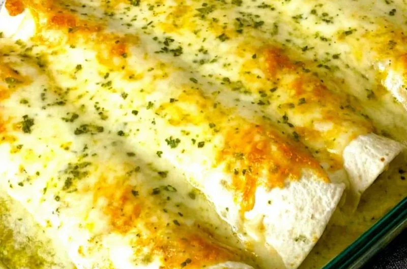Delicious white chicken enchiladas topped with creamy sauce and cheese