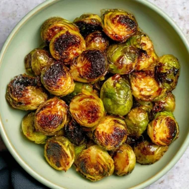 Oven roasted Maple Balsamic Brussels Sprouts garnished and ready to serve.