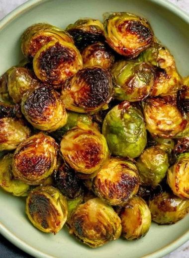 Oven roasted Maple Balsamic Brussels Sprouts garnished and ready to serve.