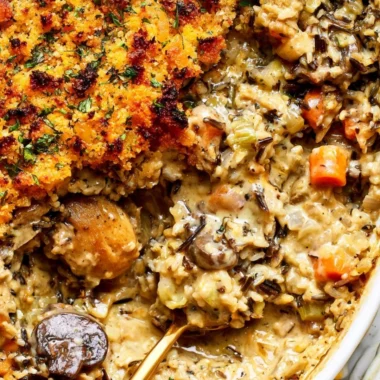 Creamy chicken wild rice casserole in a serving dish, garnished for presentation.