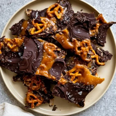 Delicious salted caramel chocolate pretzel bars on a wooden table