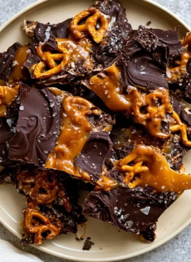 Delicious salted caramel chocolate pretzel bars on a wooden table